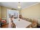 Dining room featuring a large table, chandelier, hardwood floors, crown moulding, and an open doorway at 753 Win West Xing, Auburn, GA 30011