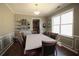 Inviting dining room with wainscoting, hardwood floors, and a view into the kitchen at 753 Win West Xing, Auburn, GA 30011