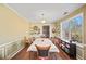 Dining room featuring a large window, chandelier, hardwood floors, and an open doorway at 753 Win West Xing, Auburn, GA 30011