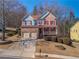 Charming two-story home with a brick facade, red shutters, front porch, and two car garage at 753 Win West Xing, Auburn, GA 30011