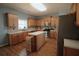 Well-lit kitchen featuring updated appliances, island, and stylish wood flooring at 753 Win West Xing, Auburn, GA 30011