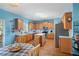 Kitchen featuring wooden cabinets, stainless steel appliances, hardwood floors, and blue walls at 753 Win West Xing, Auburn, GA 30011