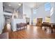 Bright living room featuring high ceilings, hardwood floors, large windows, a piano, and staircase at 753 Win West Xing, Auburn, GA 30011