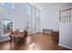 Bright living room featuring high ceilings, hardwood floors, large windows, a piano, and neutral paint at 753 Win West Xing, Auburn, GA 30011