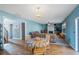 Cozy living room with fireplace, ceiling fan, hardwood flooring, and a connected dining space at 753 Win West Xing, Auburn, GA 30011