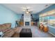 Cozy living room featuring a fireplace, built-in shelving, and large windows at 753 Win West Xing, Auburn, GA 30011