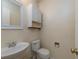 Small bathroom with white pedestal sink and toilet at 826 Shore Drive, Lithonia, GA 30058