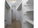 Large walk-in closet with hanging rods and shelving at 826 Shore Drive, Lithonia, GA 30058