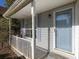 Inviting front porch with white railings and a blue front door at 826 Shore Drive, Lithonia, GA 30058