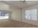 Bright living room featuring large windows and neutral carpeting at 826 Shore Drive, Lithonia, GA 30058