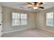 Spacious bedroom with window and ceiling fan at 2714 Legislative Ln, Buford, GA 30519