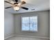 Well-lit bedroom with a ceiling fan and large window at 2714 Legislative Ln, Buford, GA 30519