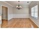 Spacious dining room featuring hardwood floors and chandelier at 2714 Legislative Ln, Buford, GA 30519