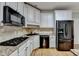 Modern kitchen with granite countertops, white cabinets, and stainless steel appliances at 2714 Legislative Ln, Buford, GA 30519