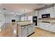 Modern kitchen with granite countertops, island, and hardwood floors at 2714 Legislative Ln, Buford, GA 30519