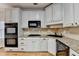 Modern kitchen with granite countertops, white cabinets, and stainless steel appliances at 2714 Legislative Ln, Buford, GA 30519