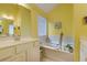 Bright bathroom with a soaking tub and a large vanity at 3529 Flowering Spgs, Powder Springs, GA 30127