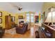 Bright living room with a fireplace, wood floors, and large windows at 3529 Flowering Spgs, Powder Springs, GA 30127