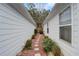 Side yard with a stone path and small bushes between the house and a fence at 3529 Flowering Spgs, Powder Springs, GA 30127