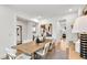 Bright dining room featuring a wooden table, seating, and a view into the kitchen at 5220 Birch Valley Rd, Cumming, GA 30028