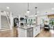 Modern kitchen with white cabinets, large island, and breakfast bar seating at 5220 Birch Valley Rd, Cumming, GA 30028