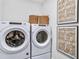 Bright laundry room, featuring Whirlpool washer and dryer, and stylish storage at 5220 Birch Valley Rd, Cumming, GA 30028