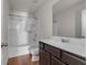 Bathroom with tub, shower, dark wood vanity, and white countertop at 7369 Saint Peter Way, Fairburn, GA 30213