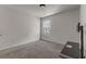 Spare bedroom with plush carpeting, TV, and window at 7369 Saint Peter Way, Fairburn, GA 30213
