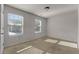 Bright bedroom with neutral carpeting and two windows providing natural light at 7369 Saint Peter Way, Fairburn, GA 30213