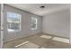 Bright bedroom with carpet flooring and two large windows at 7369 Saint Peter Way, Fairburn, GA 30213