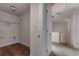 Hallway view of a walk-in closet with hardwood floors and wire shelving at 7369 Saint Peter Way, Fairburn, GA 30213