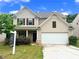 Charming two-story home featuring a two-car garage and a well-maintained front yard at 7369 Saint Peter Way, Fairburn, GA 30213