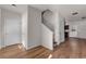 Open foyer with hardwood floors leading to the staircase and other rooms at 7369 Saint Peter Way, Fairburn, GA 30213