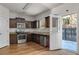 Modern kitchen with stainless steel appliances, dark wood cabinets, and hardwood floors at 7369 Saint Peter Way, Fairburn, GA 30213