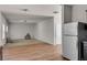 Spacious living area with hardwood and carpeted floors, along with a stainless-steel refrigerator at 7369 Saint Peter Way, Fairburn, GA 30213