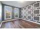 Bedroom with gray walls, wood floors, and geometric accent wall at 860 Constellation Dr, Decatur, GA 30033