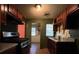Galley kitchen with dark wood cabinets and granite countertops at 1357 Sharon St, Atlanta, GA 30314