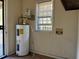 Laundry area with water heater, window, and utility hookups at 1357 Sharon St, Atlanta, GA 30314