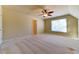 Bright bedroom featuring a ceiling fan and window with blinds at 5705 Upper Creek Ct, Suwanee, GA 30024