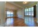 Formal dining room with hardwood floors, chandelier, and adjacent Gathering room at 5705 Upper Creek Ct, Suwanee, GA 30024