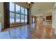 Gathering room with hardwood floors, large windows, and view of kitchen at 5705 Upper Creek Ct, Suwanee, GA 30024