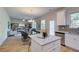 Open concept dining area with glass table, and view into the living room at 591 River Gardens Se Dr, Atlanta, GA 30354