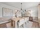 Modern dining room featuring a light wood table and neutral decor at 1617 Tide Mill Rd, Cumming, GA 30040