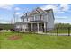 Two-story home with gray siding, brick accents, and a landscaped yard at 1617 Tide Mill Rd, Cumming, GA 30040