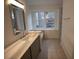 Bright bathroom featuring a vanity with marble countertop and a shower/tub combo at 500 Chimney House Ct, Stone Mountain, GA 30087