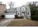 Gray two-story house with white garage door and landscaping at 500 Chimney House Ct, Stone Mountain, GA 30087