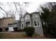 Gray two-story house with white garage door, landscaping, and basketball hoop at 500 Chimney House Ct, Stone Mountain, GA 30087