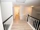 Upstairs hallway with light gray walls and hardwood floors at 500 Chimney House Ct, Stone Mountain, GA 30087