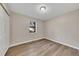 Simple bedroom with wood-look flooring and neutral walls at 80 Yvette Ne Ct, Kennesaw, GA 30144