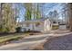 Newly renovated house with green door and driveway, surrounded by trees at 80 Yvette Ne Ct, Kennesaw, GA 30144